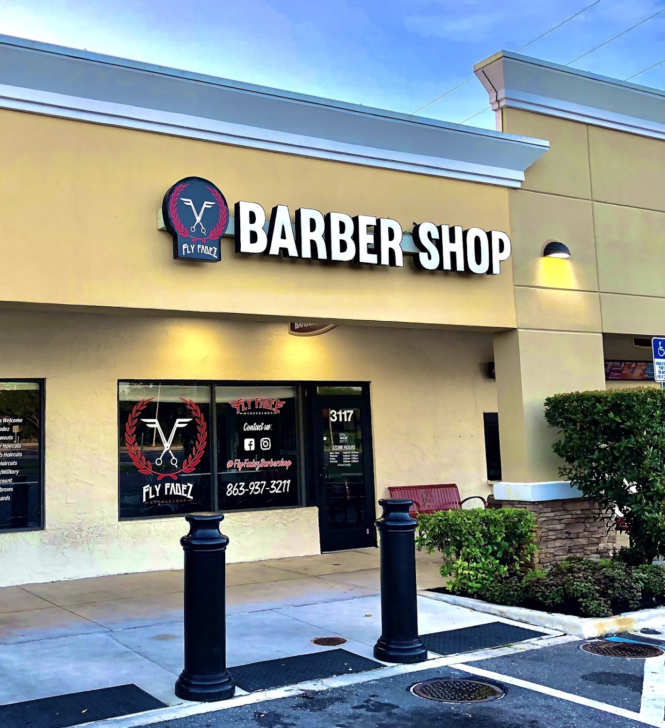 The Fly Fadez Barbershop storefront on US Hwy 98 N, with the crest logo and BARBER SHOP sign above the door